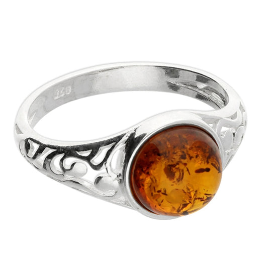 Cognac amber cabachon framed with cut-out swirl shoulders